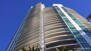 Modern high-rise building against clear blue sky.