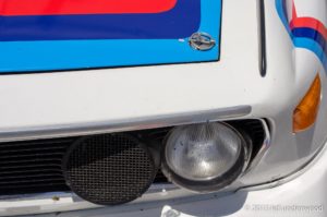 Close-up of a vintage race car headlight.