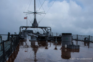 Ship deck with cloudy sky background.