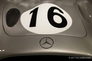 Silver car with number 16 and logo.