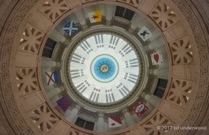Dome ceiling with colorful emblem designs.
