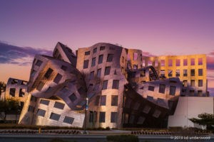 Deconstructivist building at sunset, wavy architecture.