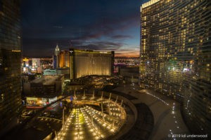 City skyline at night with illuminated buildings.