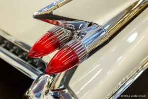 Classic car tail fins with red lights.